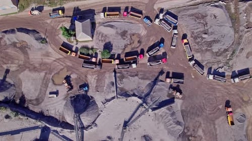 Excavator Loading Crushed Stone Into a Dump Truck in a Crushed Stone Quarry