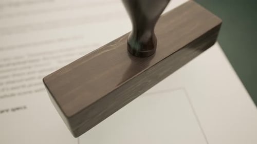 An important document being approved by green office stamp in slow motion. 4KHD