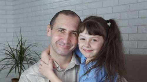 Loving Father and Daughter Embrace Affectionately
