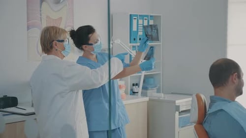 Dentists Examining X-Rays in a Dental Clinic