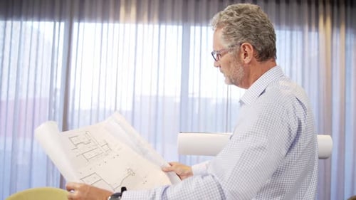 Architect looking at blueprint