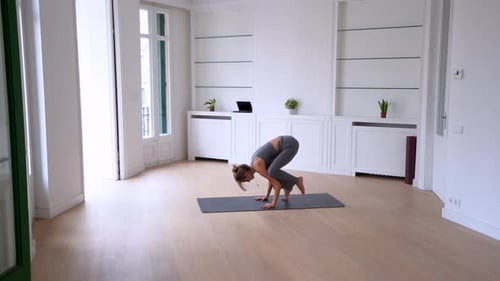 Young Woman Practicing Yoga Headstand Pose