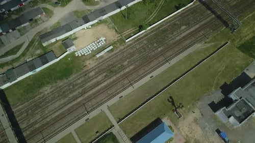Flug über den S-Bahnhof. Eisenbahnschienen und Schwellen sind sichtbar.