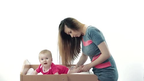 Woman Massaging Baby on Changing Table