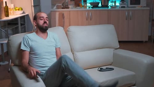 Man with Beard Relaxing on Couch at Home