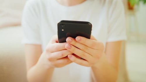 Hands Holding Black Smartphone, Close Up