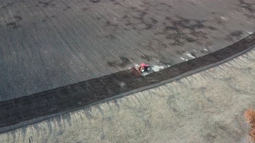 Agricultural Tractor Plows Soil Field for Sowing Aerial Top View From the Drone
