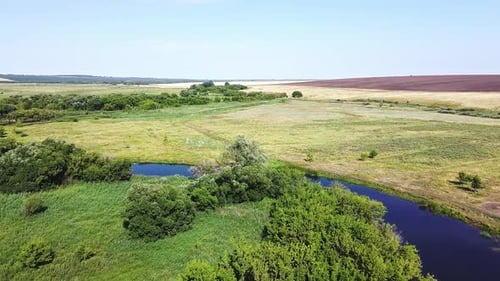 Picturesque Nature, Aerial View. The Drone Flies Over Green Trees and Blue River