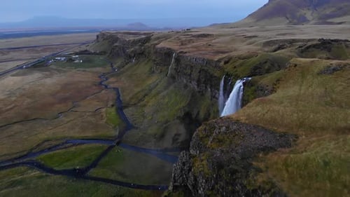 Waterfalls in green mountainous terrain