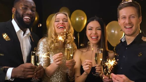 Four Friends Celebrating with Sparklers and Champagne