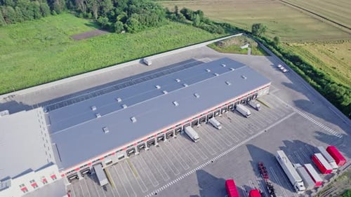 Buildings of Logistics Center Warehouses Near the Highway
