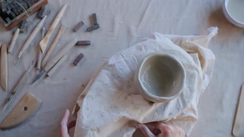 Hands Smoothing Edge of Ceramic Bowl