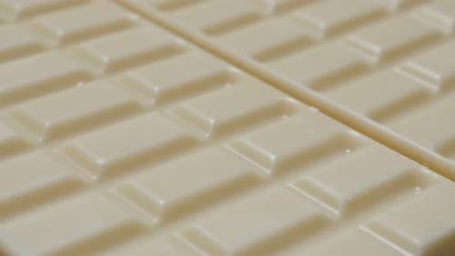 White milk chocolate surface blocks in a row sweet background slow tilt 4K 2160p 30fps UltraHD video