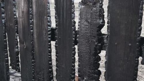 Burnt Fence Boards After a Fire in a Private House