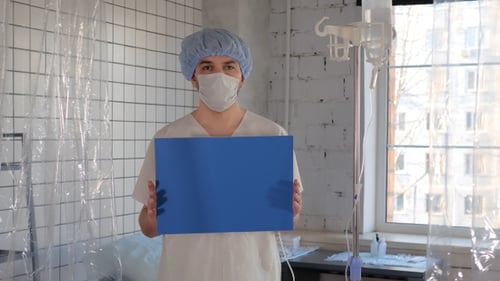 Young male patient in a protective medical mask in a hospital