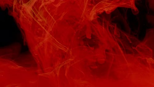 Red Ink Swirling in Dark Water Abstract