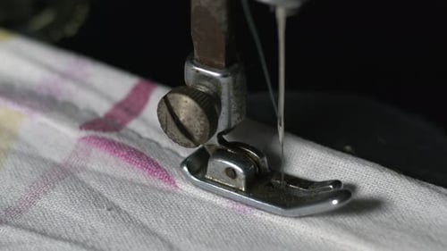 Vintage Sewing Machine Sewing White Striped Fabric