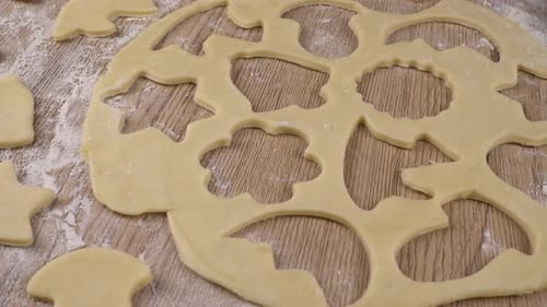 Cookie Dough with Cookie Cutters on Wood Table