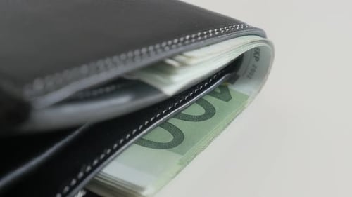 Tilting over leather wallet full of green banknotes 3840X2160 UltraHD footage - Euro paper currency