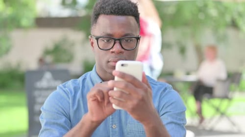 Man Using Smartphone Outdoors in Urban Setting