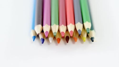Close-up of colored pencils arranged in a row