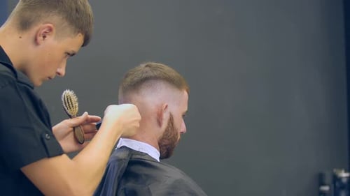 Man Getting Haircut at a Barber Shop