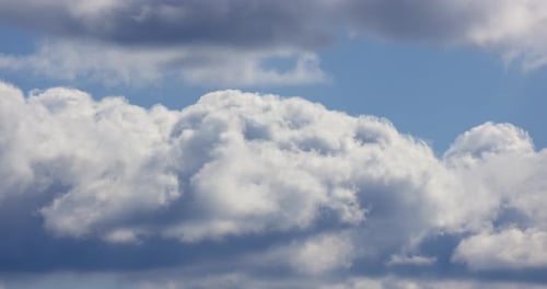 Clouds Moving Across Bright Blue Sky Time Lapse