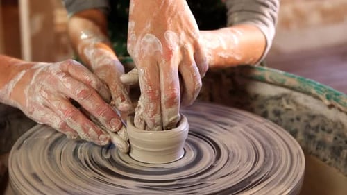 Hands Molding Clay on Pottery Wheel
