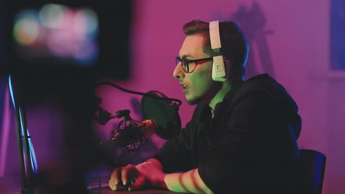 Young Man Speaking into Microphone in Studio