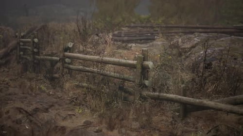 An Old Wood Fence with a Country Field Behind It