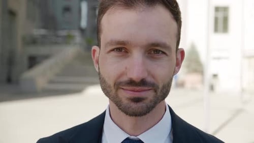 Man Smiling in Front of Modern Building