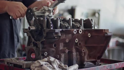 Parts Of Car Engine Being Repaired At Workbench In Repair Shop