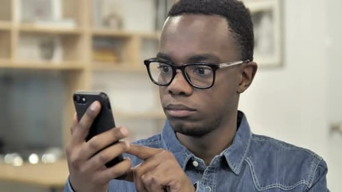 Young Adult Using Smartphone Indoors