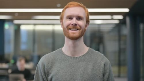 Red Haired Man Smiling in Office Close Up
