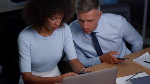Woman and Man Work at Laptop in Office