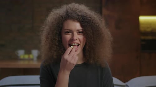 Woman Laughing and Eating Chips Close Up