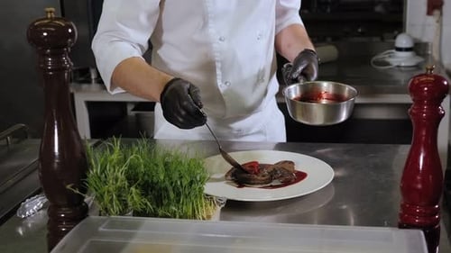 Chef Plating Elegant Gourmet Food in Kitchen