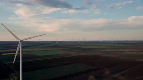 Wind Turbines Spinning in Open Rural Landscape