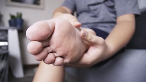 Adult Massaging Sole of Foot with Hands