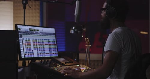 Man Recording His Own Voice Part in Studio