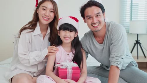 Smiling Family Celebrating Christmas with Gift Giving