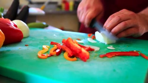 Close Up of Cook Chopping Vegetables on Cutting Board