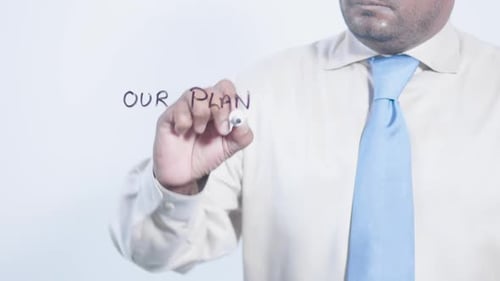 Man Writes "Our Plan" on Glass Surface