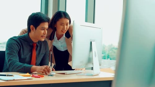 Two Business People Talk Project Strategy at Office