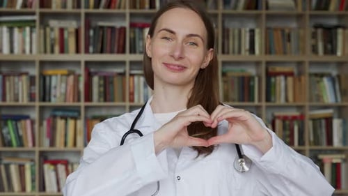 Smiling Doctor Woman Makes Heart Shape With Hands