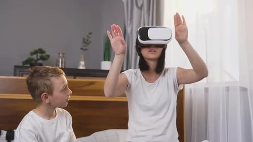 Woman with VR Headset Interacting with Child