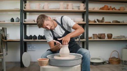 Young Adult Making Pottery in Studio