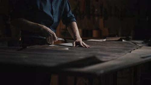 Close Up Shot of Unrecognizable Man Tailor Cutting Leather at Workshop Preparing Blanks for Shoe