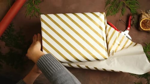 Wrapping Christmas Gift with Gold Striped Paper