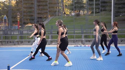 Group of Women Performing Lunges in Urban Park